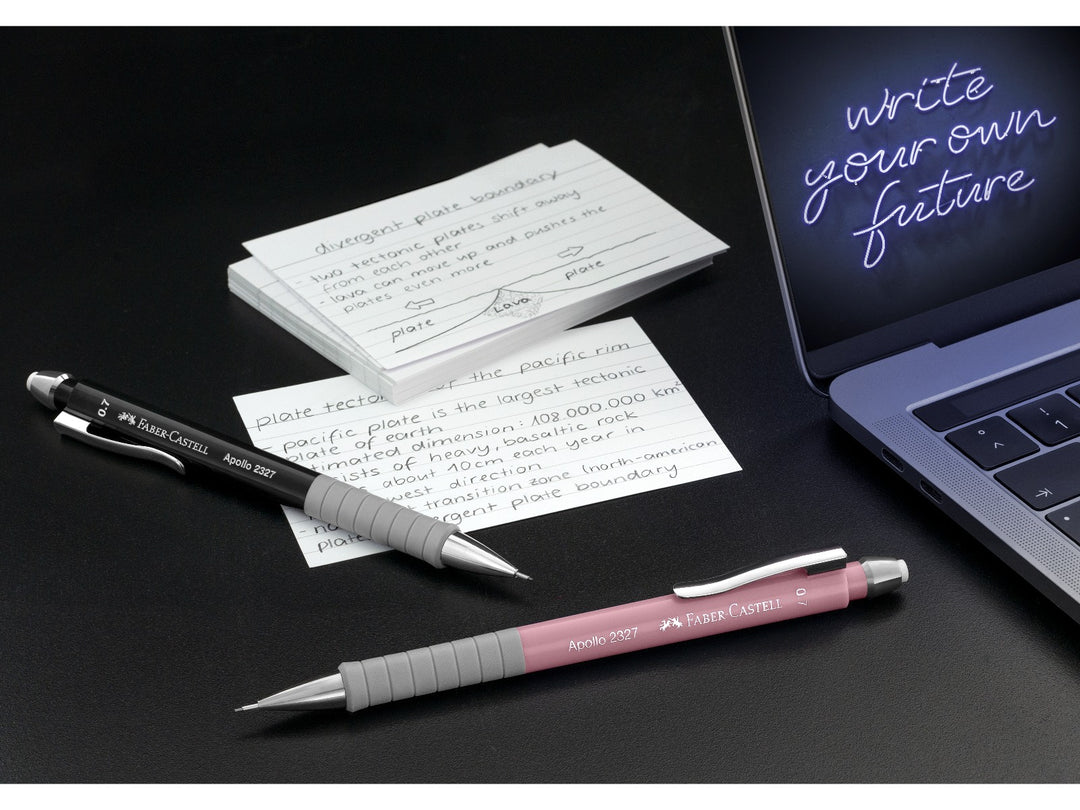 Faber-Castell Apollo Mechanical Pencils in Black and Pale Rose displayed with handwritten study notes beside a laptop, demonstrating the ergonomic soft-grip zone, retractable 0.7mm lead sleeve, metal pocket clip and comfortable design for everyday writing, note-taking, studying and technical work.