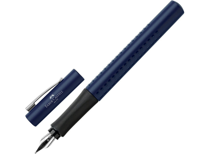 Faber-Castell Grip 2011 Fountain Pen in Classic Blue shown writing a handwritten letter on white paper, featuring an ergonomic triangular barrel with patented Grip dots, durable stainless steel nib and metal pocket clip for comfortable everyday handwriting, journaling, note-taking and professional writing.