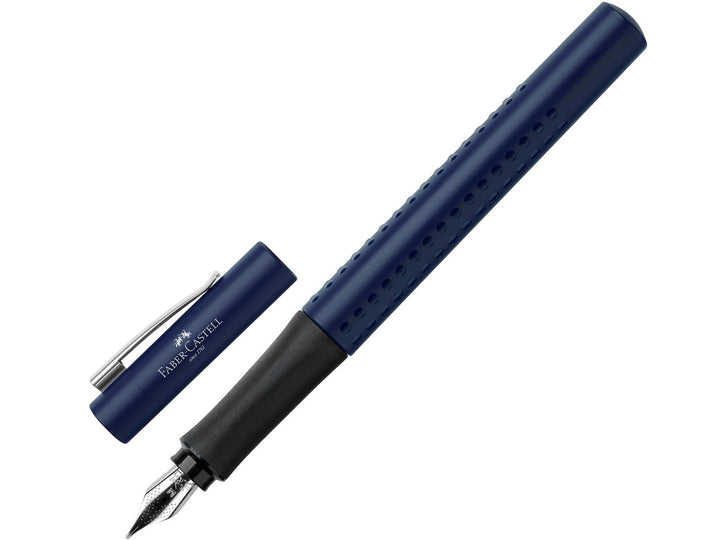 Faber-Castell Grip 2011 Fountain Pen in Classic Blue with cap removed, featuring an ergonomic triangular barrel with patented Grip dots, durable stainless steel nib, metal pocket clip and comfortable design for everyday handwriting, journaling, note-taking and professional writing.