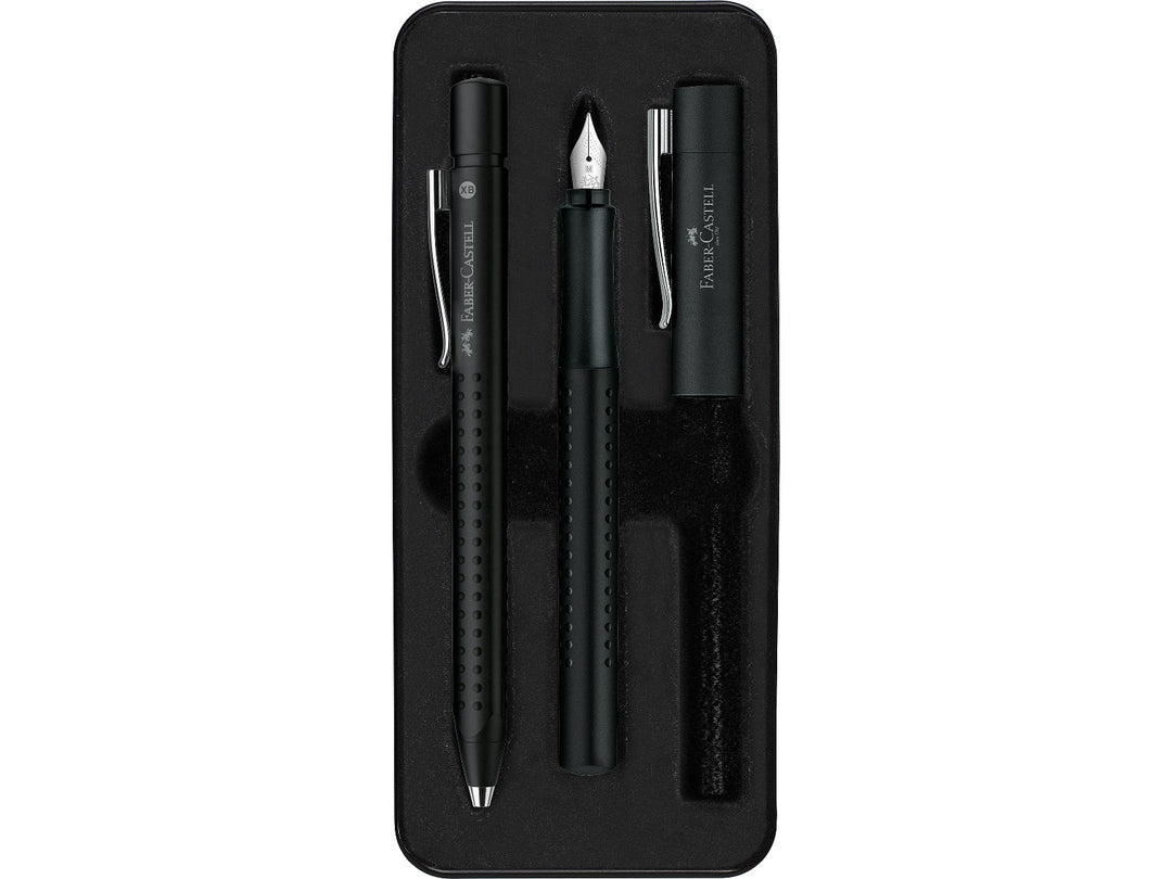 Close-up of the Faber-Castell Grip 2011 Fountain Pen Gift Set Black 2 Pieces displayed inside its presentation tray, featuring a matching black fountain pen with stainless steel nib and coordinating ballpoint pen, both with ergonomic Grip dot barrels, metal clips and comfortable everyday writing design.