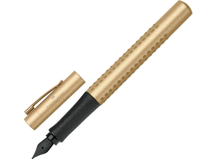 Faber-Castell Grip Edition Fountain Pen in Gold with cap removed, featuring a metallic gold barrel with ergonomic Grip dots, durable stainless steel extra fine nib, metal pocket clip and lightweight design for precise everyday handwriting, journaling, note-taking and professional writing.