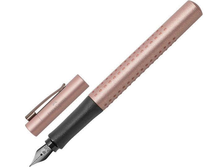 Faber-Castell Grip Edition Fountain Pen in Rose Copper with cap removed, featuring a metallic rose copper barrel with ergonomic Grip dots, durable stainless steel nib, metal pocket clip and lightweight design for everyday handwriting, journaling, note-taking and professional writing.