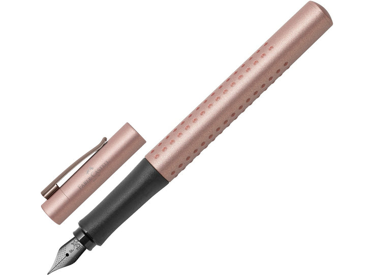 Faber-Castell Grip Edition Fountain Pen in Rose Copper with cap removed, featuring a metallic rose copper barrel with ergonomic Grip dots, durable stainless steel nib, metal pocket clip and lightweight design for everyday handwriting, journaling, note-taking and professional writing.
