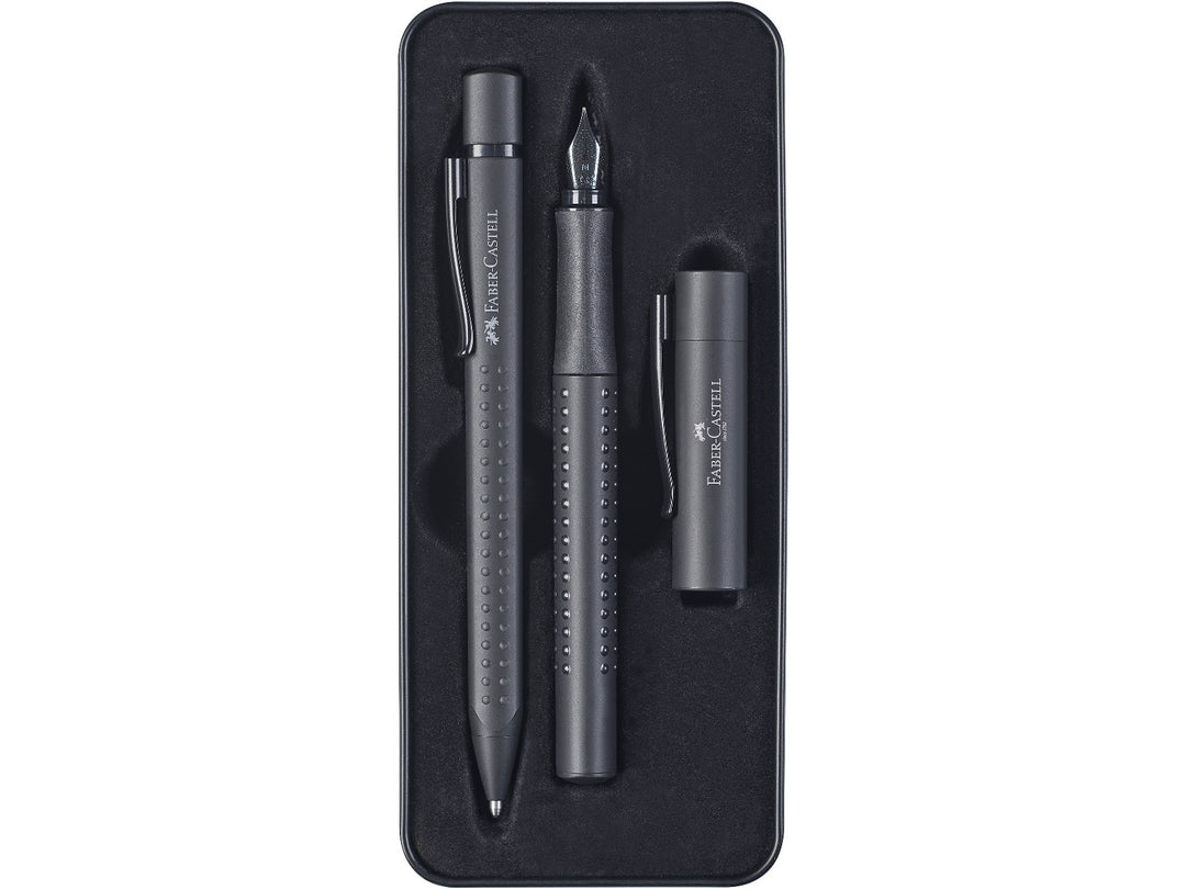 Close-up of the Faber-Castell Grip Edition Writing Gift Set Black displayed inside its presentation tray, featuring a matching black fountain pen with stainless steel nib and coordinating ballpoint pen, both with ergonomic Grip dot barrels, matte black finish, metal clips and comfortable everyday writing design.