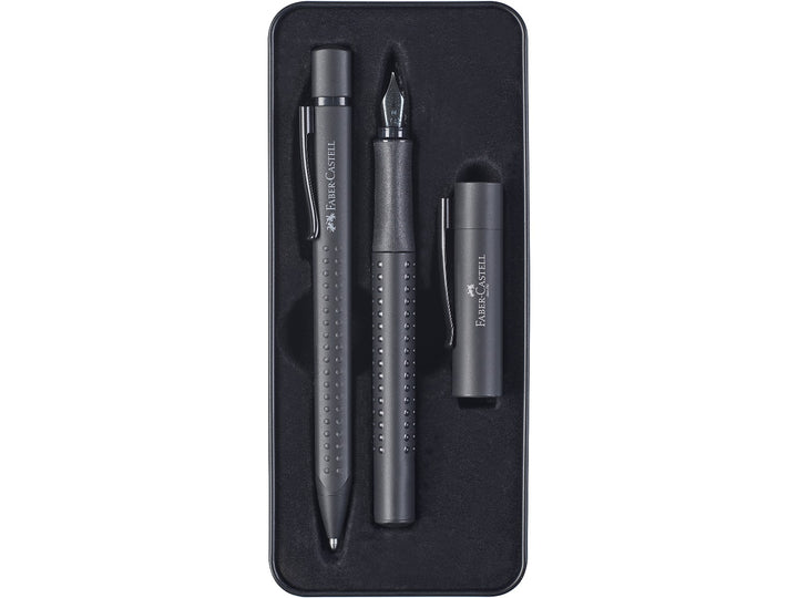Close-up of the Faber-Castell Grip Edition Writing Gift Set Black displayed inside its presentation tray, featuring a matching black fountain pen with stainless steel nib and coordinating ballpoint pen, both with ergonomic Grip dot barrels, matte black finish, metal clips and comfortable everyday writing design.