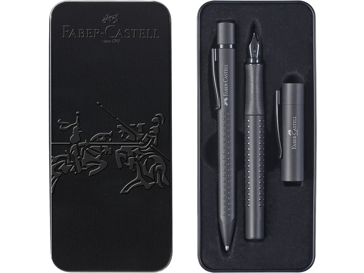 Lifestyle image featuring the Faber-Castell Grip Edition Glam Writing Set Pearl in use, showing the matching pearl-effect fountain pen and ballpoint pen alongside a notebook and coordinating stationery accessories, highlighting the ergonomic Grip dot design, shimmering pearlescent finish and elegant everyday writing performance for journaling, planning, studying and creative writing.