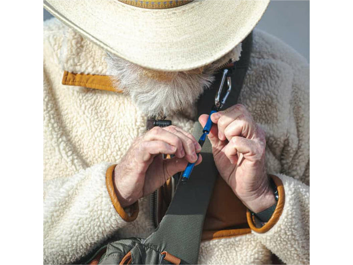 Fisher Space Pen Backpacker blue pen attached to backpack strap used for outdoor everyday carry