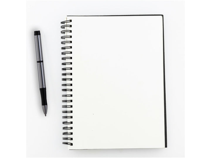 Fisher Space Pen Pocket‑Tec silver pen next to open spiral notebook on blank page