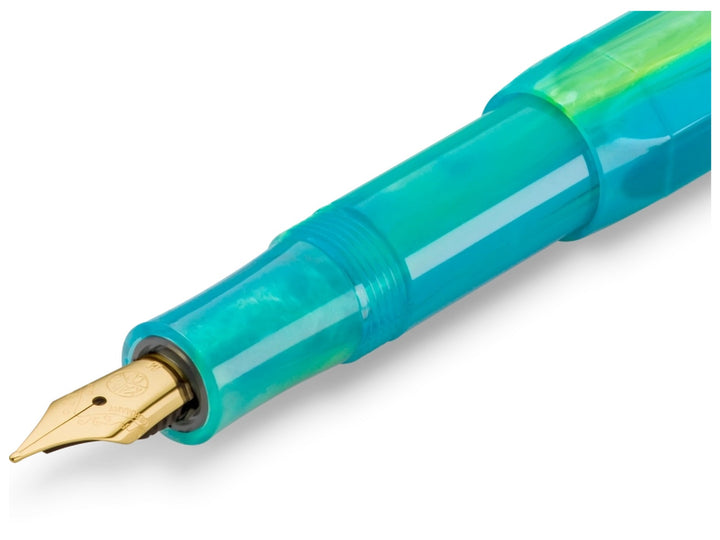 Detailed view of the Kaweco COLLECTION Marble Ocean fountain pen showing the gold-plated nib, glossy blue grip section and ocean-inspired marbled resin body