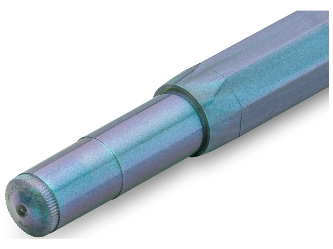 Close-up detail of the Kaweco LUNAR SPORT Fountain Pen in Shadow Blue, showcasing the translucent barrel and grip section with shimmering turquoise and violet accents, faceted octagonal Sport design and satin-like finish