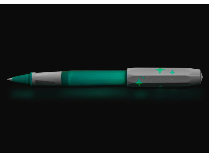Kaweco PERKEO Glow rollerball pen shown glowing blue-green in the dark, highlighting the luminescent barrel, grip section and star-patterned cap design
