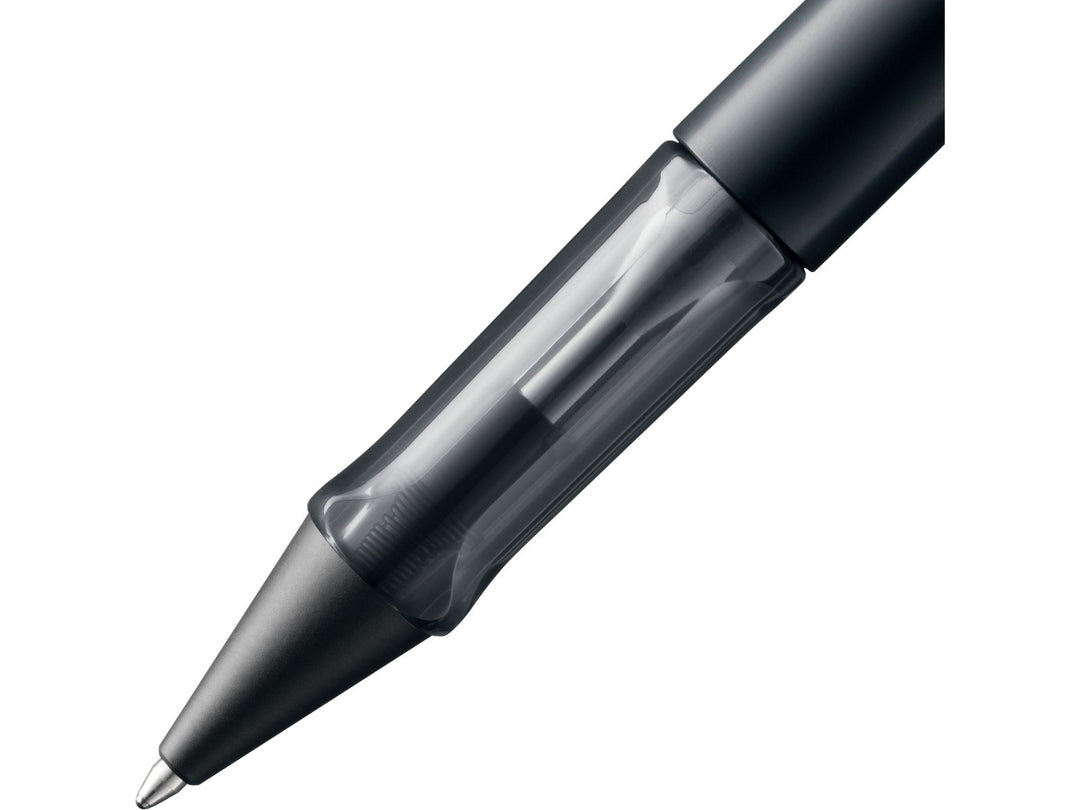 Close-up of the LAMY AL-star ballpoint pen in Black, showing the transparent ergonomic grip section, anodised aluminium barrel and retractable ballpoint tip
