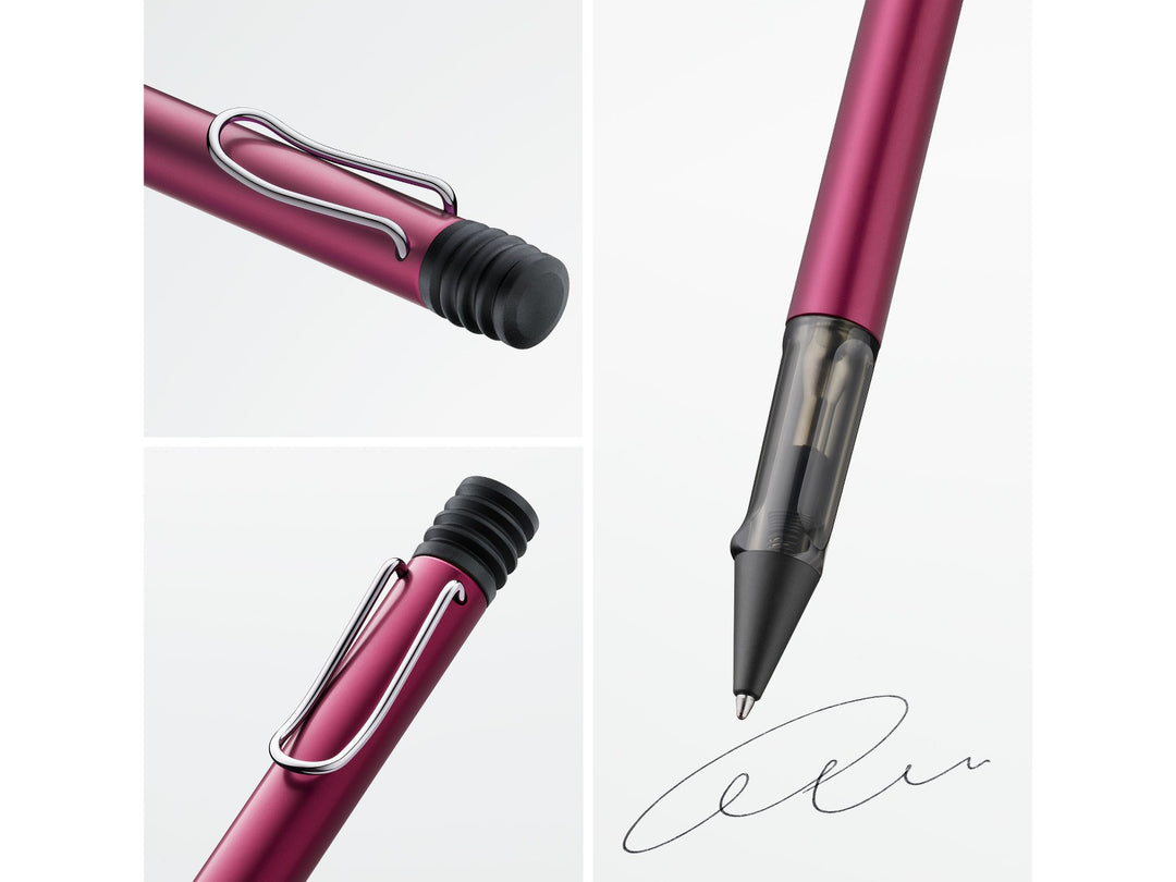 Close-up details of the LAMY AL-star ballpoint pen in Black Purple, highlighting the self-sprung metal clip, translucent smoke-grey ergonomic grip section, anodised aluminium body and retractable ballpoint writing tip
