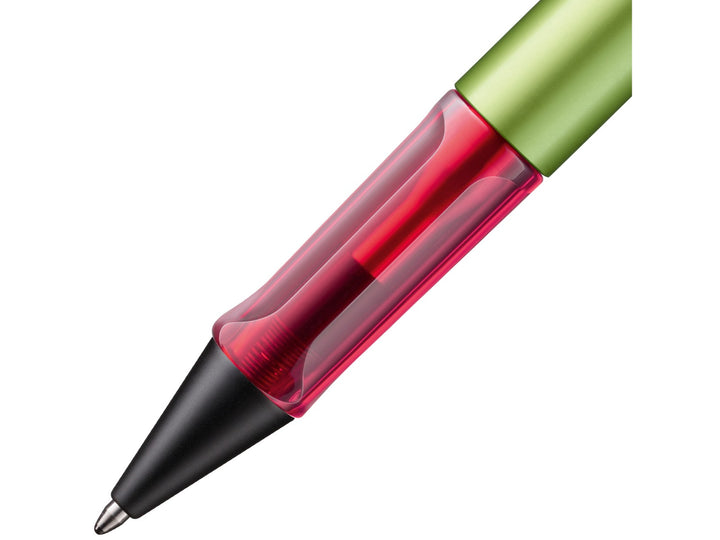 Close-up of the LAMY AL-star ballpoint pen in Disco Special Edition, showing the transparent pink ergonomic grip section, anodised aluminium barrel and retractable ballpoint tip