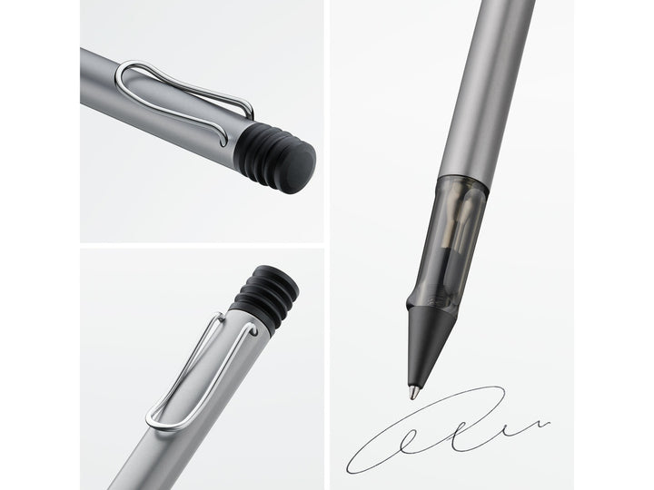 Close-up details of the LAMY AL-star ballpoint pen in Graphite, highlighting the self-sprung metal clip, translucent smoke-grey ergonomic grip section, anodised aluminium body and retractable ballpoint writing tip
