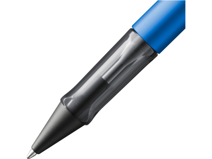 Close-up of the LAMY AL-star ballpoint pen in Ocean Blue, showing the transparent ergonomic grip section, anodised aluminium barrel and retractable ballpoint tip