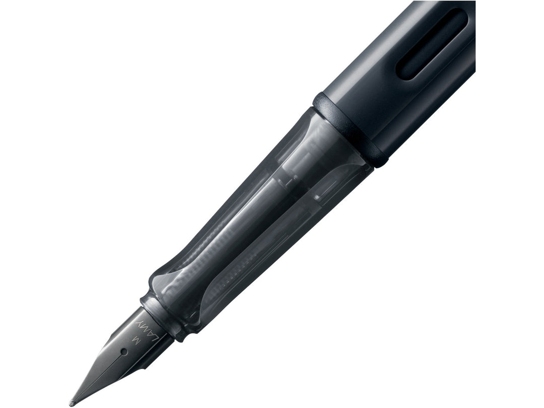 LAMY AL-star black fountain pen close-up of stainless steel nib, transparent grip section and ink window