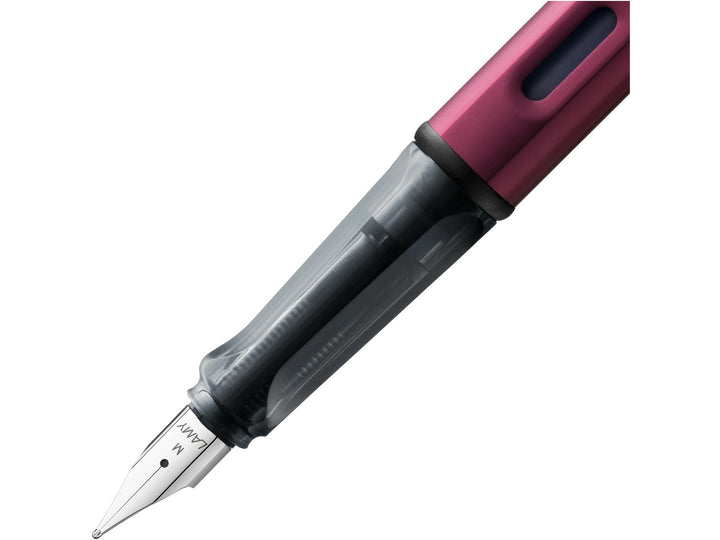LAMY AL-star black purple fountain pen close-up of stainless steel nib, transparent grip section and ink window