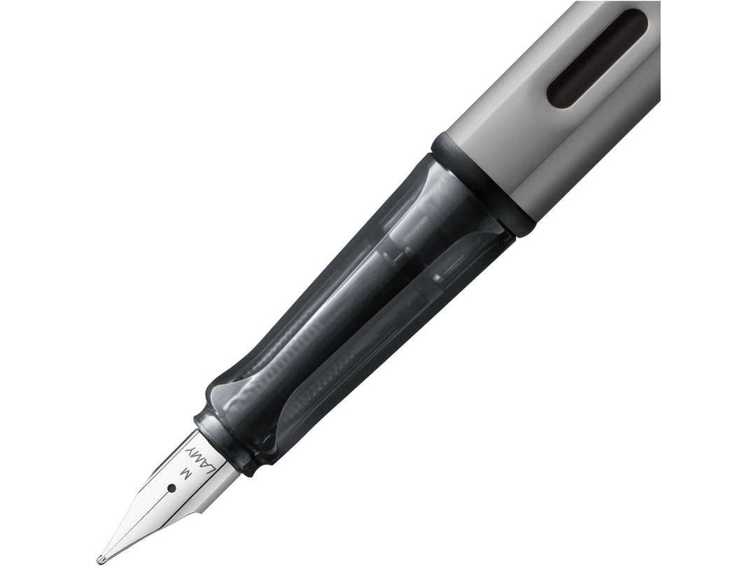 LAMY AL-star graphite fountain pen close-up of stainless steel nib, transparent grip section and ink window