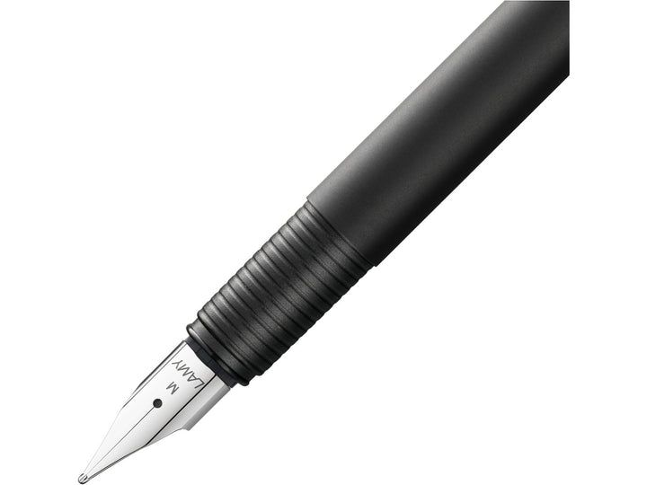 LAMY cp1 fountain pen close-up showing a polished steel nib and ribbed grip section on a slim black cylindrical barrel