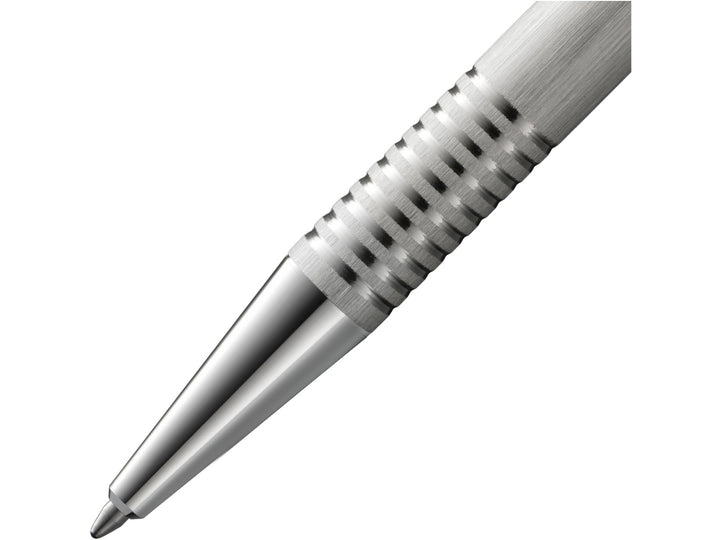 Close-up of the LAMY logo Ballpoint Pen in Brushed Stainless Steel featuring the polished metal cone tip, distinctive ribbed grip section and brushed stainless steel barrel construction