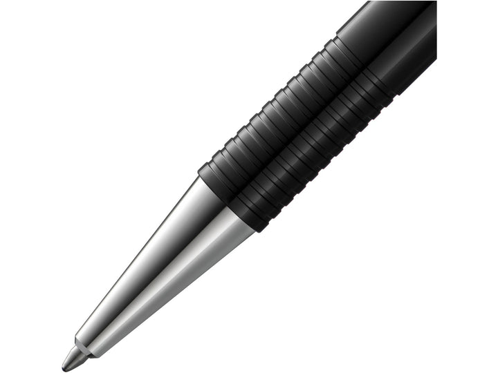 Close-up of the LAMY logo M+ Ballpoint Pen in Black featuring the polished metal cone tip, distinctive ribbed grip section, matte black barrel and durable lightweight construction