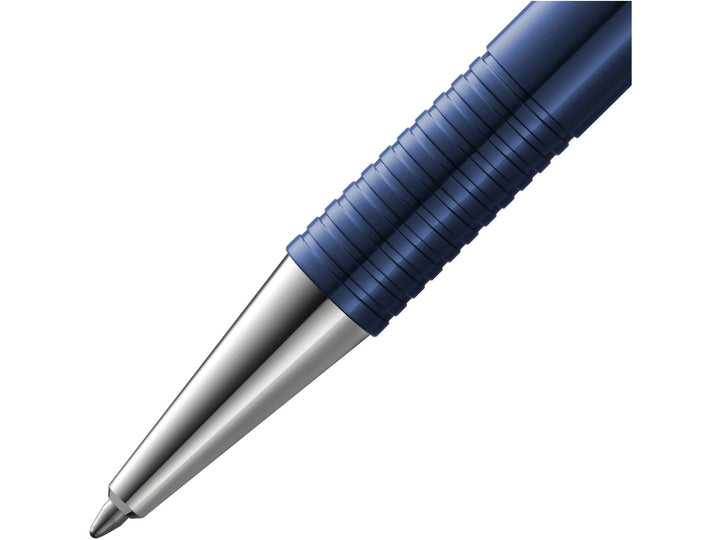 Close-up of the LAMY logo M+ Ballpoint Pen in Blue featuring the polished metal cone tip, distinctive ribbed grip section, deep blue barrel and durable lightweight construction