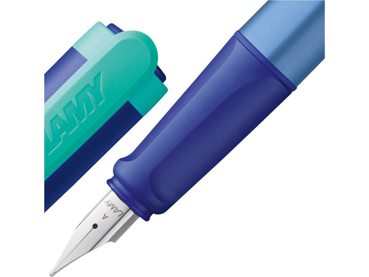 LAMY nexx Multiblue Special Edition fountain pen close-up showing a soft ergonomic non-slip grip section, polished stainless steel A nib and translucent blue cap