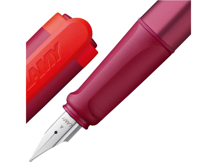 LAMY nexx Multired Special Edition fountain pen close-up showing a soft ergonomic non-slip grip section, polished stainless steel A nib and red cap