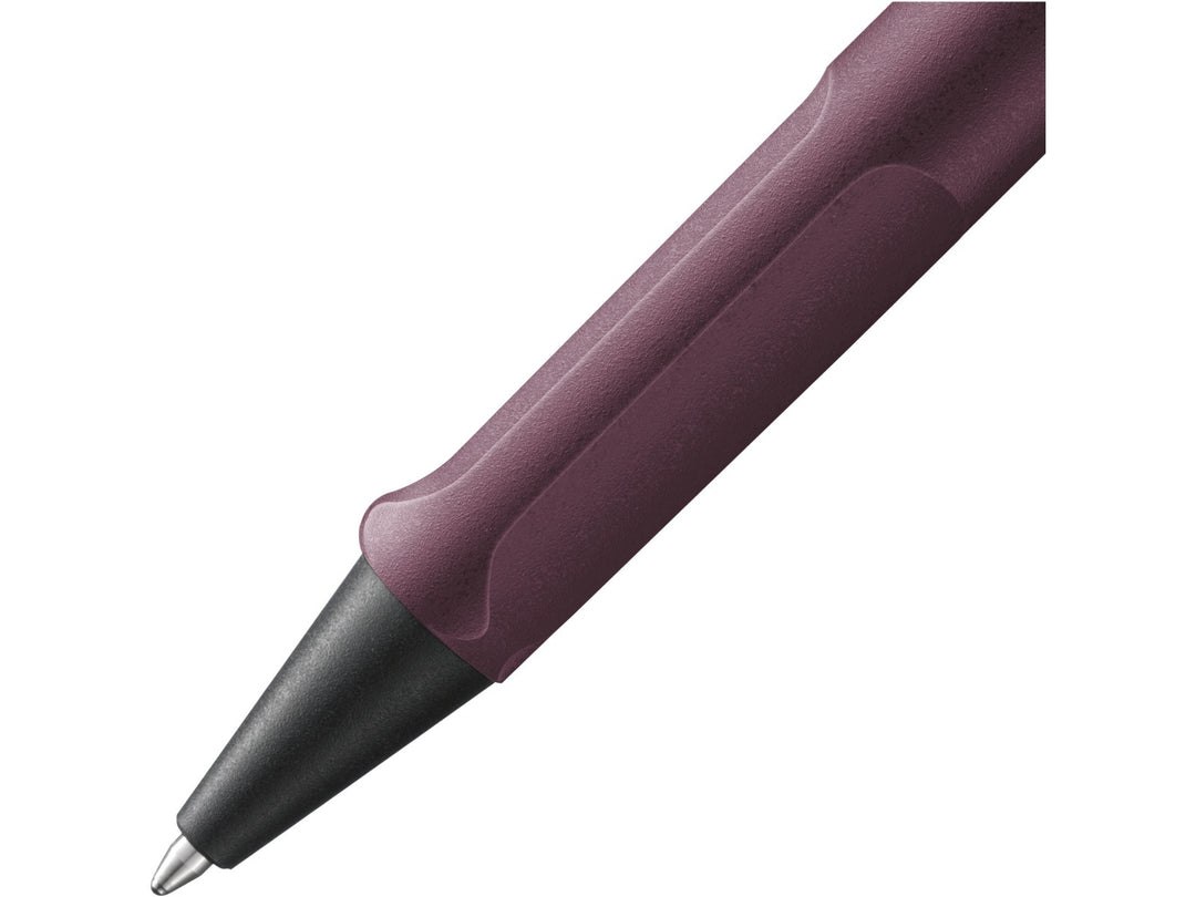 Close-up of the LAMY safari Ballpoint Pen in Scarlet featuring the ergonomic moulded grip section, black cone tip and durable ASA plastic construction in a dark burgundy-red finish