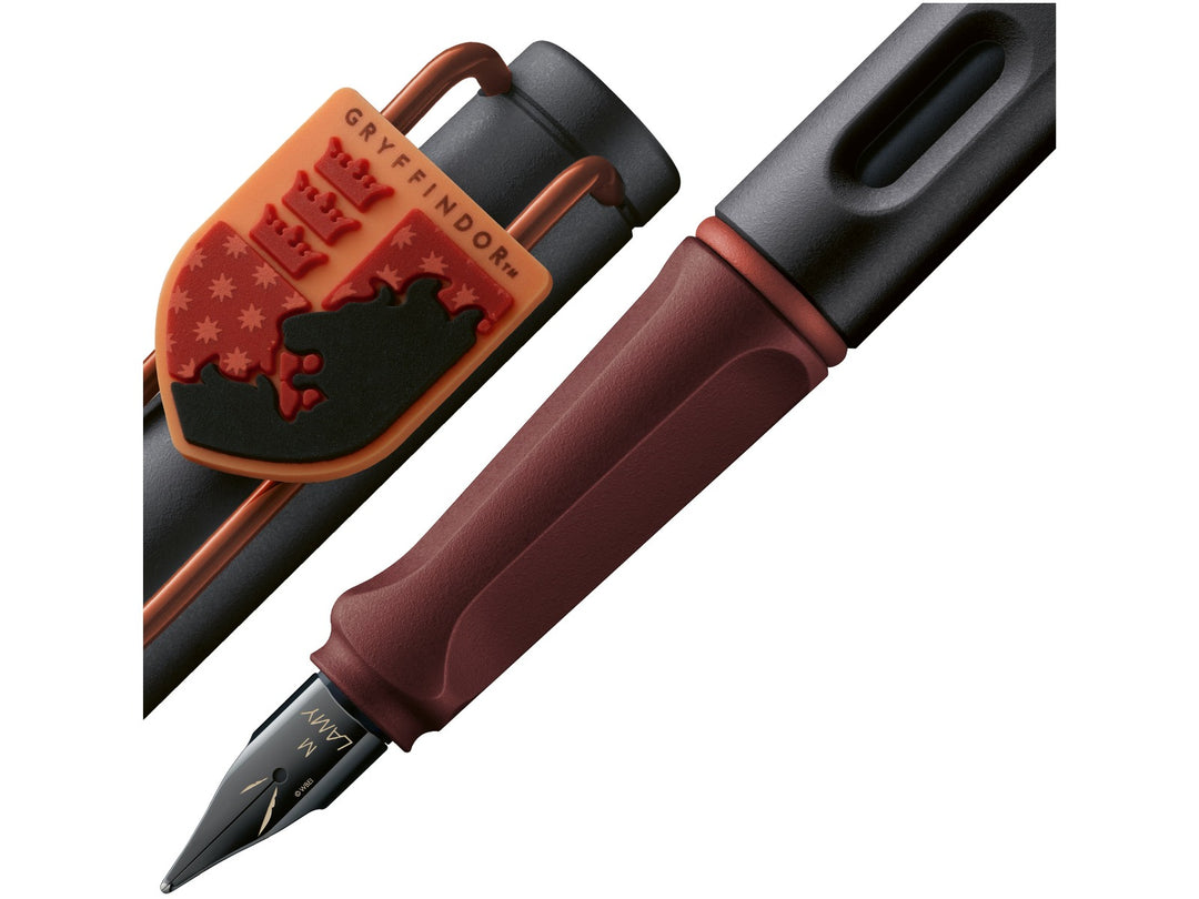 LAMY safari Harry Potter Gryffindor fountain pen detail showing Gryffindor crest charm, ergonomic grip section and black steel nib