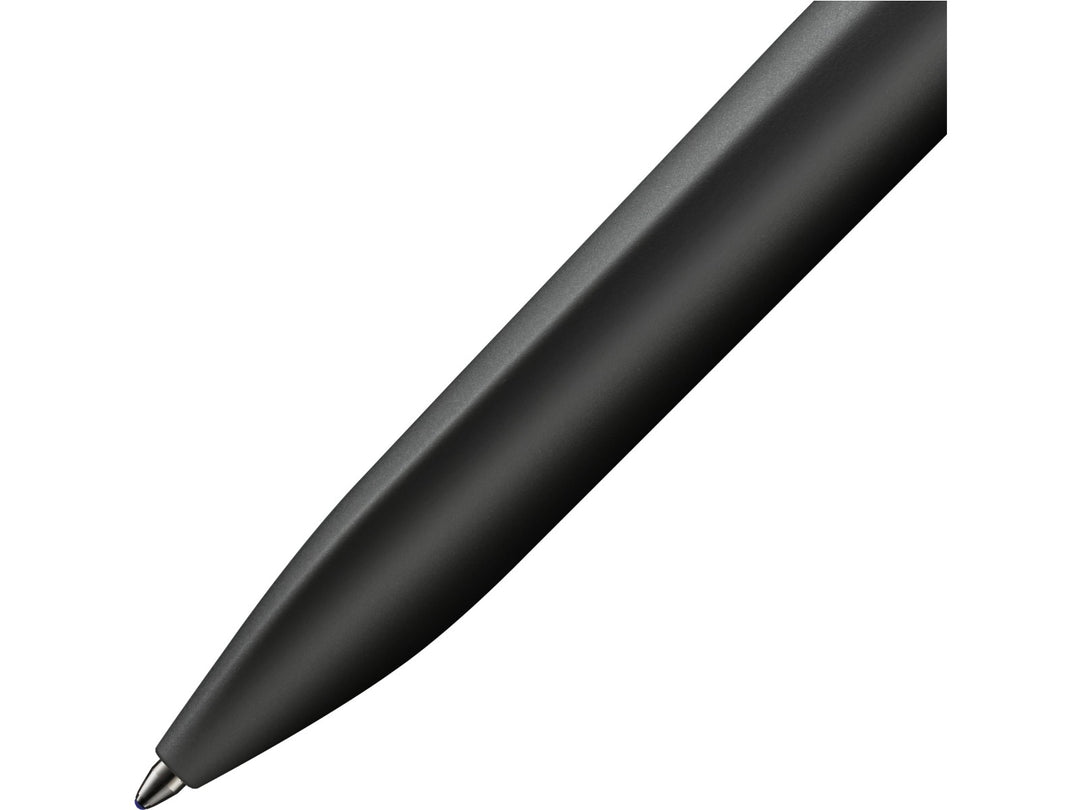 Close-up of the LAMY xevo ballpoint pen in black, highlighting the seamless transition from the ergonomic triangular grip section to the rounded barrel and the precision ballpoint writing tip
