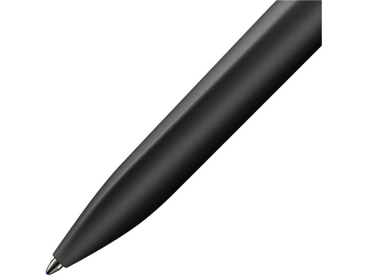 Close-up of the LAMY xevo ballpoint pen in black, highlighting the seamless transition from the ergonomic triangular grip section to the rounded barrel and the precision ballpoint writing tip