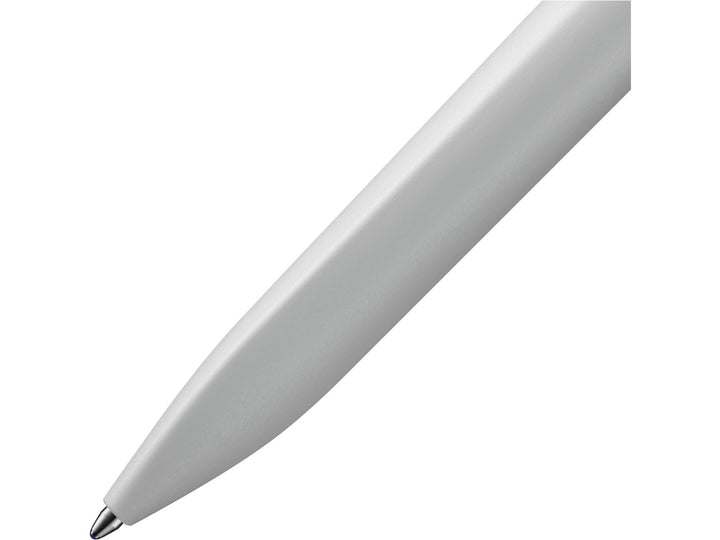 Close-up of the LAMY xevo ballpoint pen in light grey, highlighting the seamless transition from the ergonomic triangular grip section to the rounded barrel and the precision ballpoint writing tip