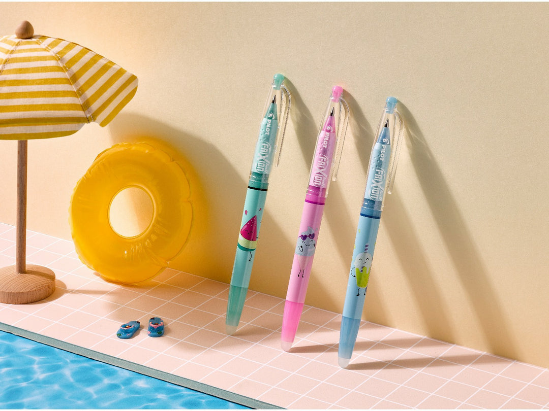 Pilot FriXion Ball 0.7 Pool Party Edition Sunny, Frosty and Bubbly erasable rollerball pens displayed in a colourful poolside scene with a yellow inflatable ring and striped parasol