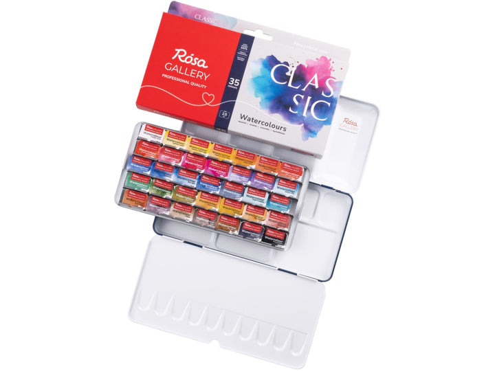 ROSA Gallery Classic Watercolour Set showing 35 professional watercolour half pans arranged in a metal travel case with integrated mixing palette, accompanied by updated Classic Collection packaging featuring vibrant blue and pink watercolour artwork and a versatile colour palette designed for watercolour painting, sketching and illustration