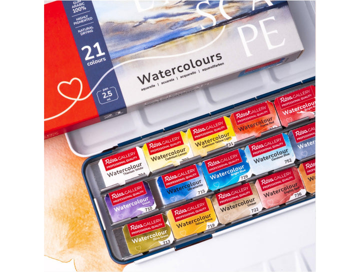 Close-up of the ROSA Gallery Landscape Watercolour Set featuring 21 professional watercolour half pans arranged in a metal travel case with integrated mixing palette, showcasing the curated landscape colour selection and updated Landscape Collection packaging designed for plein air painting, urban sketching and capturing natural scenery.
