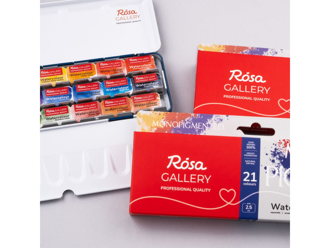 Lifestyle image of the ROSA Gallery Monopigmented Watercolour Set featuring updated Monopigmented Collection packaging alongside an open metal watercolour case with 21 professional single-pigment watercolour half pans and integrated mixing palette surfaces, showcasing a palette developed for pure colour, clean mixing and professional watercolour painting