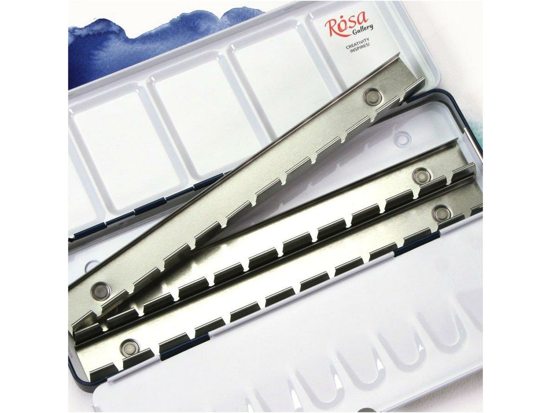 Close-up of the ROSA Gallery Indigo watercolour metal case interior, showcasing the removable metal pan holder rails, integrated mixing palette surfaces and organised layout designed to hold 21 full watercolour pans for customised palette creation