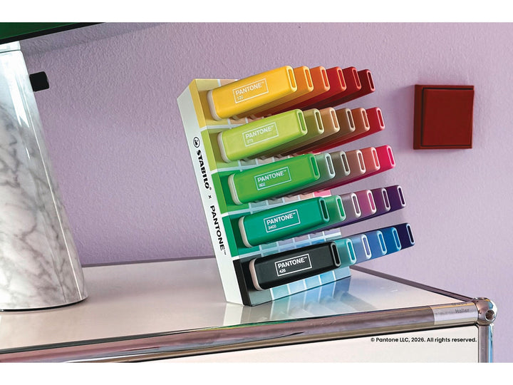 STABILO BOSS ORIGINAL x PANTONE desk set of 30 highlighters displayed upright on a modern desk, showing the full colour spectrum and PANTONE colour-numbered barrels
