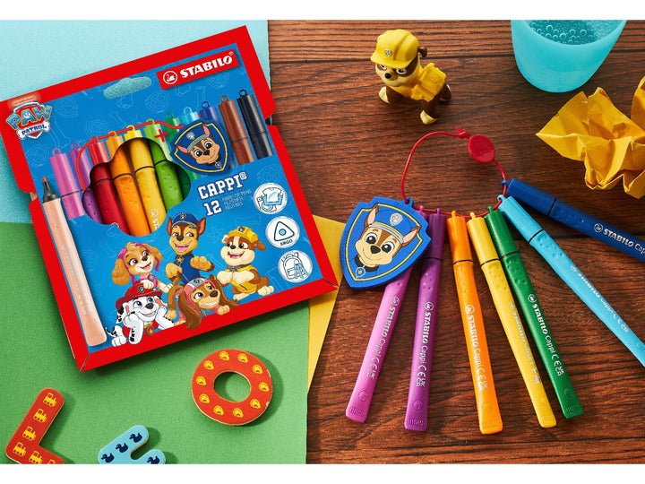 STABILO Cappi PAW Patrol set of 12 felt-tip pens displayed with the retail wallet, cap ring and Chase police badge on a colourful creative desk