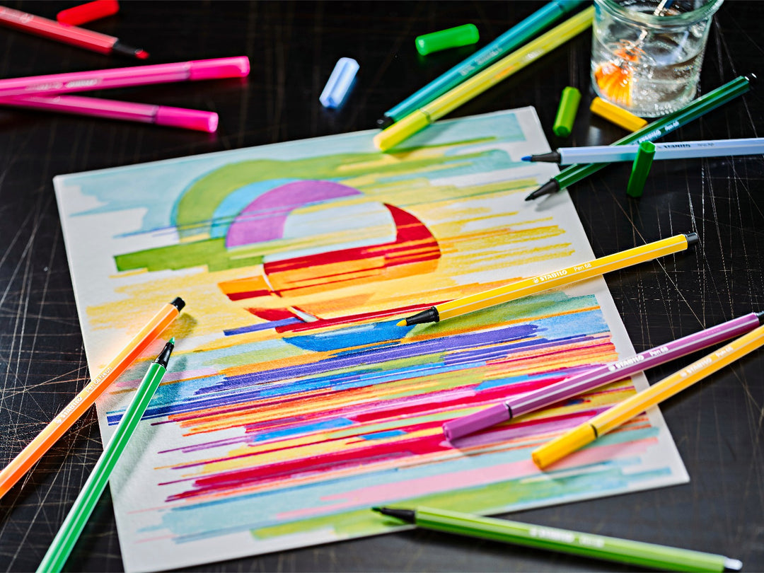 Assorted STABILO Pen 68 felt-tip pens displayed around a vibrant multicoloured abstract drawing, showcasing bright colours for colouring, sketching and creative artwork