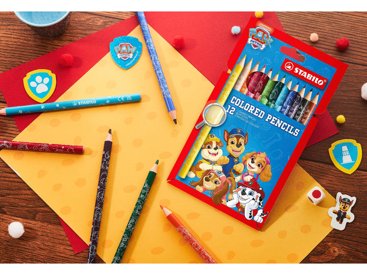 STABILO PAW Patrol coloured pencils and Pack of 12 displayed on a colourful craft desk with PAW Patrol accessories and assorted drawing materials