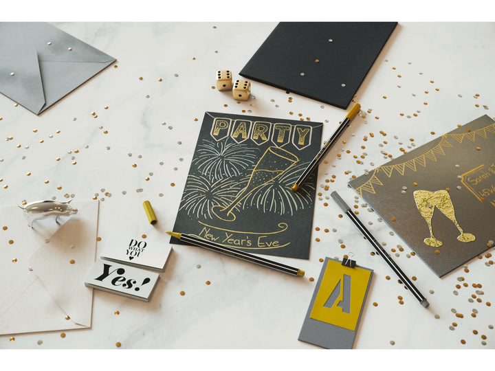 STABILO Pen 68 Metallic felt-tip pens displayed with black and grey party invitations decorated in shimmering gold and silver, showcasing metallic drawing, lettering and creative decoration