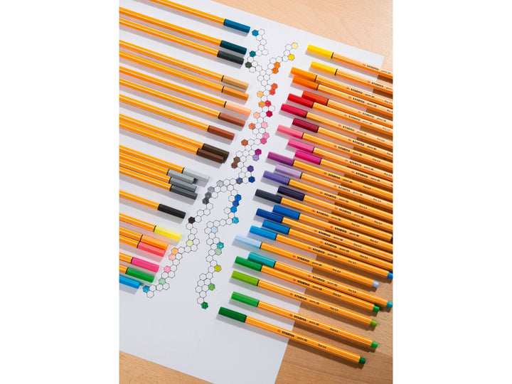 Assorted STABILO point 88 fineliner pens arranged around a geometric colour chart, showcasing a wide range of bright 0.4mm fineliner colours for detailed drawing and creative work