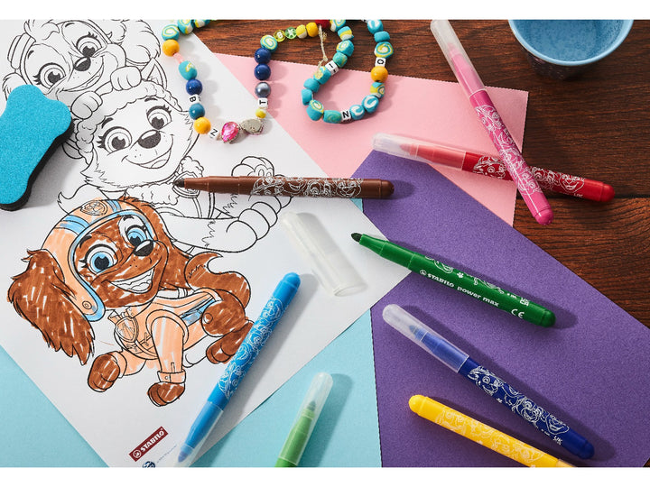 STABILO power max PAW Patrol felt-tip pens in assorted colours being used on a PAW Patrol colouring sheet, surrounded by colourful paper and craft accessories