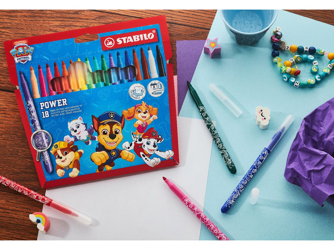 STABILO power PAW Patrol Wallet of 18 felt-tip pens displayed on a colourful craft desk with assorted uncapped markers, paper and creative accessories