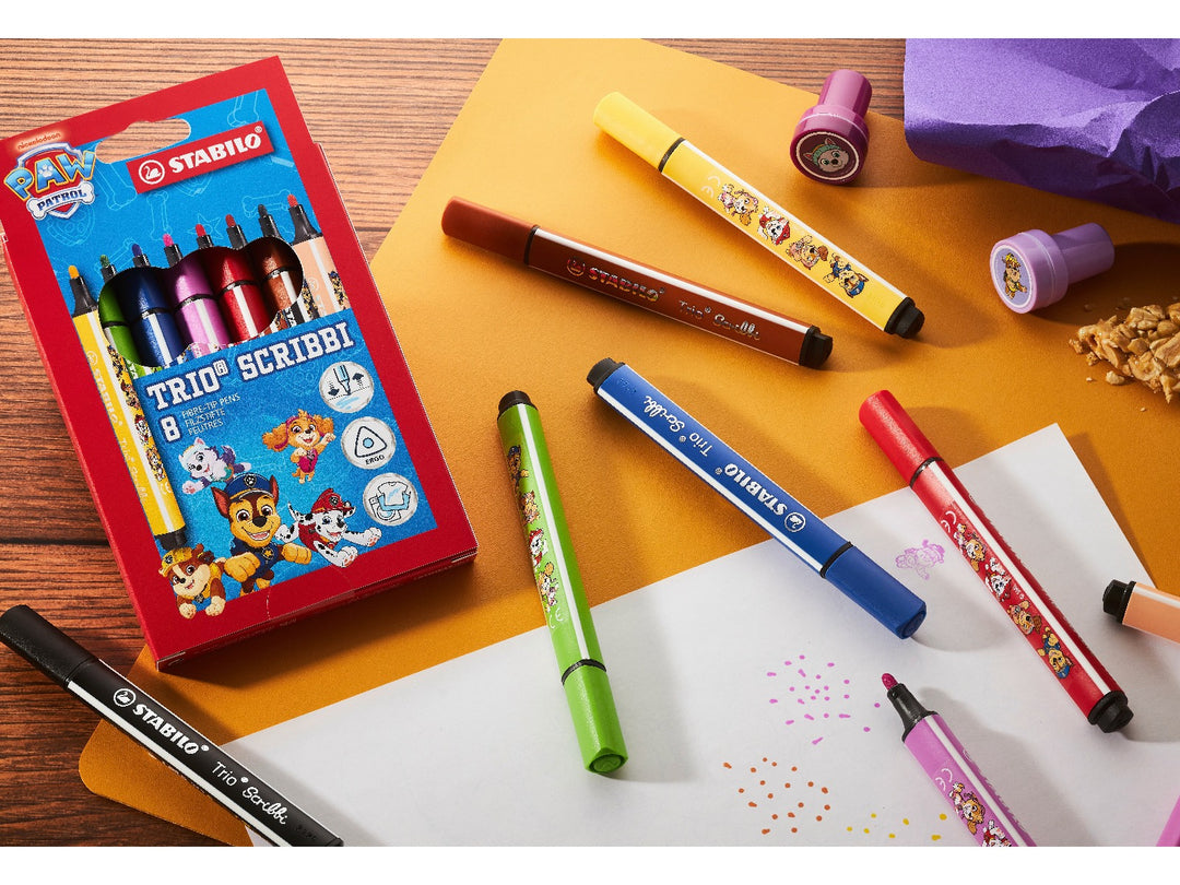 STABILO Trio Scribbi PAW Patrol Wallet of 8 felt-tip pens displayed with assorted colourful pens, caps and drawing marks on a creative desk