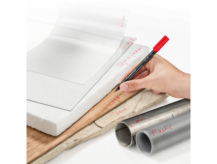 STAEDTLER Lumocolor permanent pen 313 superfine 0.4 mm writing on multiple surfaces demonstrating versatile marking use
