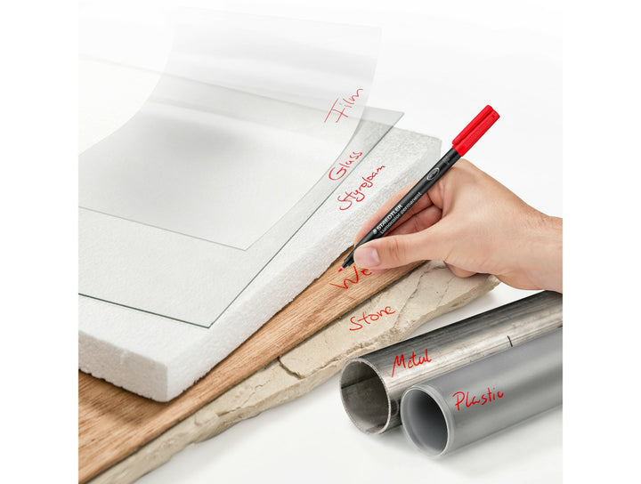 STAEDTLER Lumocolor permanent pen 318 fine 0.6 mm used for multi surface marking showing controlled red writing on various materials